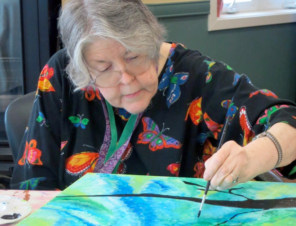 Painter painting artwork on table