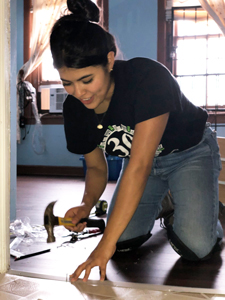 RTP volunteer laying a new floor
