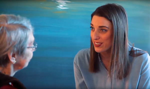 Wellness Coordinator Michelle Roth talking to a resident