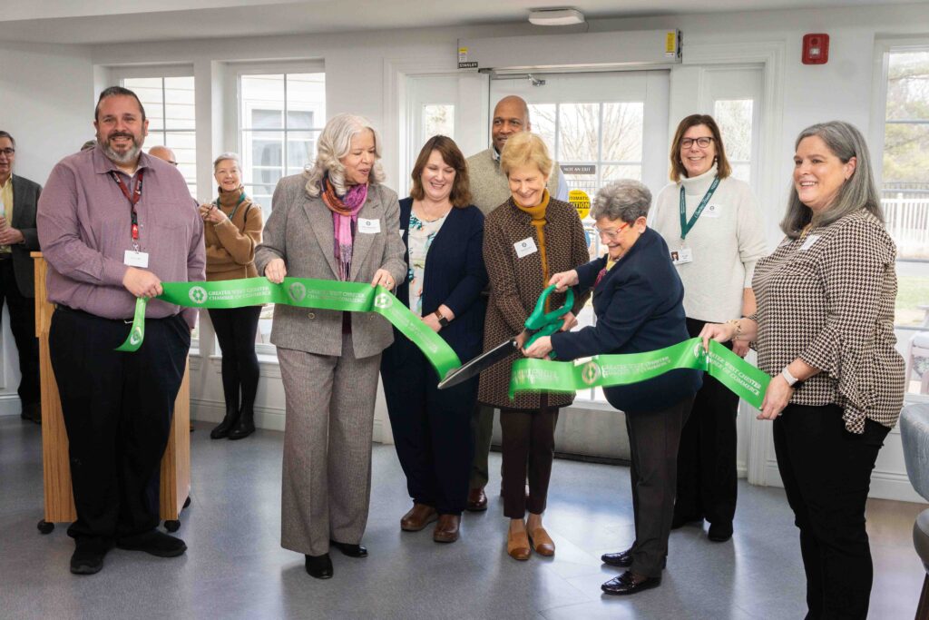 Seven people cutting ribbon